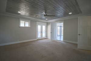 Carpeted Primary bedroom with french doors, ceiling fan, recessed lighting, and ornamental molding