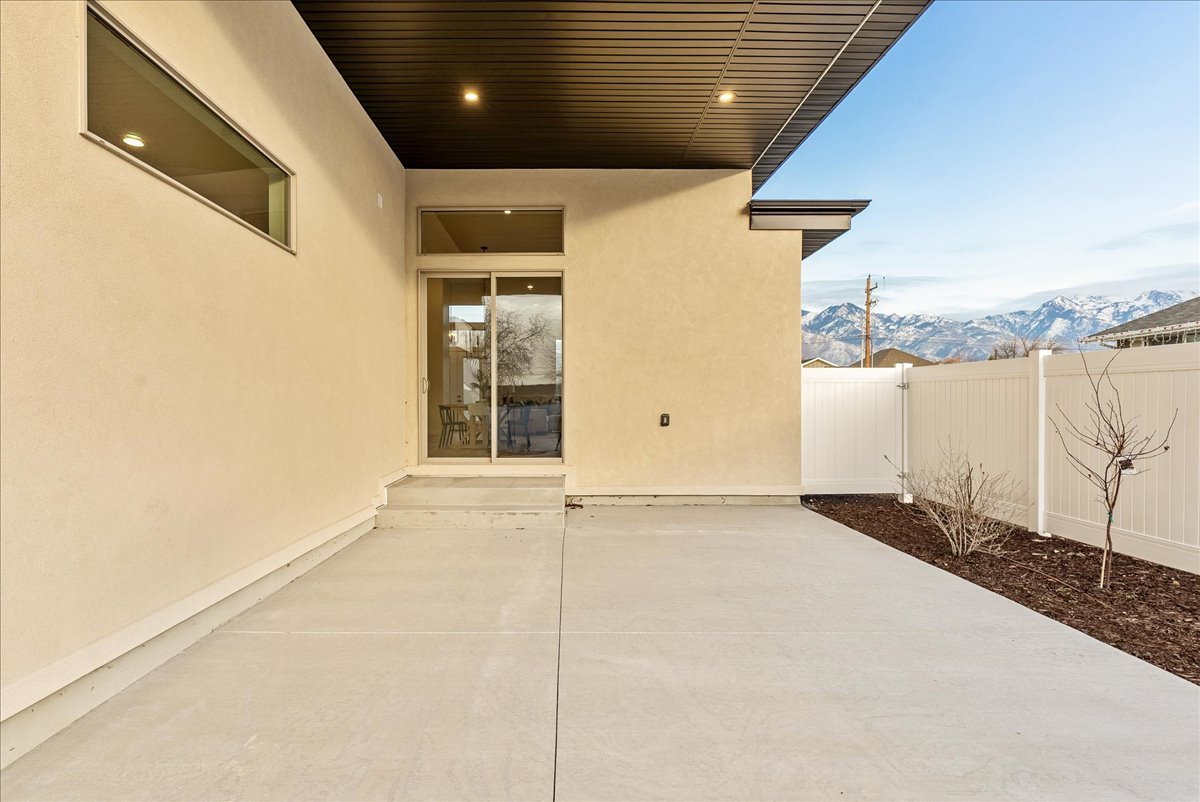 Fenced backyard with a mountain view and a patio area