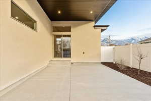Fenced backyard with a mountain view and a patio area