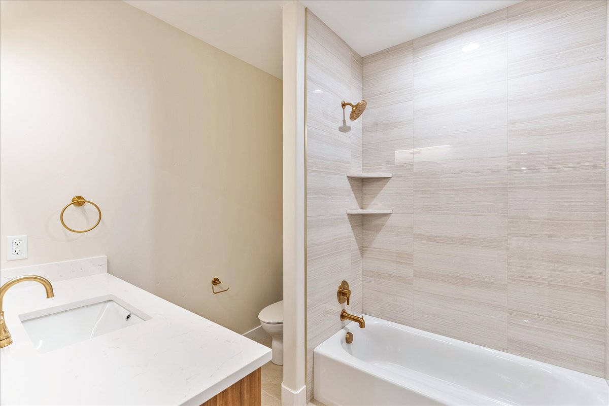 Bathroom featuring shower / tub combination and vanity