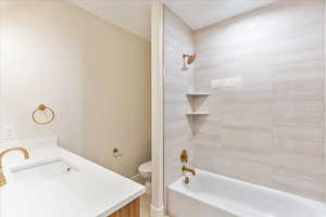 Bathroom featuring shower / tub combination and vanity