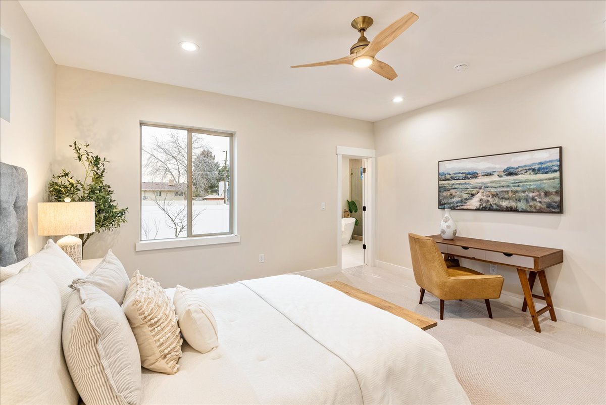 Primary bedroom with a ceiling fan and recessed lighting