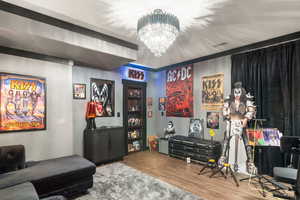 Bar featuring wood finished floors and a chandelier