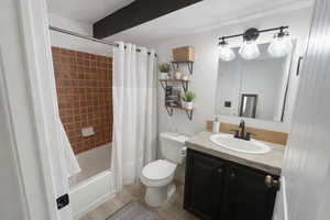 Bathroom featuring shower / bath combo, vanity, and light wood finished floors