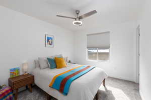 Bedroom featuring light colored carpet and a ceiling fan