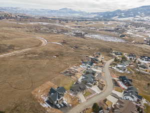 Aerial view of property's location with nearby suburban area, mountains, and rural landscape