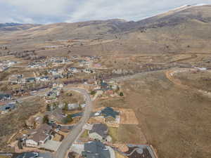 Aerial view of property's location with nearby suburban area and a mountainous background