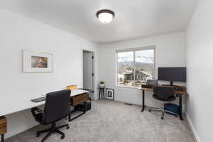 Office space featuring light colored carpet and baseboards