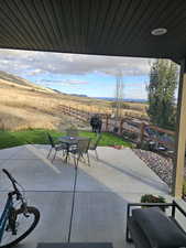 View of patio / terrace with outdoor dining area, a mountain view, and a rural view
