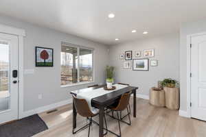 Dining area featuring light wood-style floors and recessed lighting