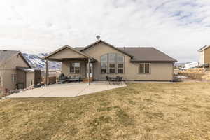 Rear view of property featuring a yard, a patio, outdoor seating, and stucco siding