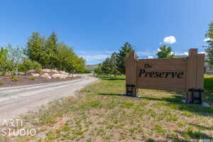 Community / neighborhood sign featuring a lawn