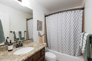 Full bath with vanity and shower / bath combination with curtain