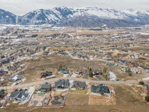 Aerial view of property's location with a mountainous background and nearby suburban area