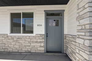 Entrance to property with stone siding