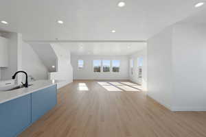 Unfurnished living room featuring light wood-style floors and recessed lighting