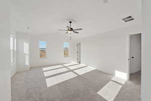 Spare room with light colored carpet and ceiling fan