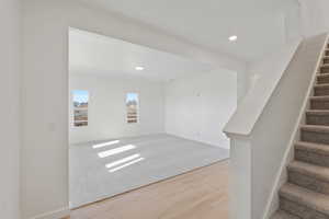 Basement with recessed lighting and light wood finished floors