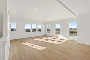 Unfurnished living room featuring light wood-type flooring and recessed lighting