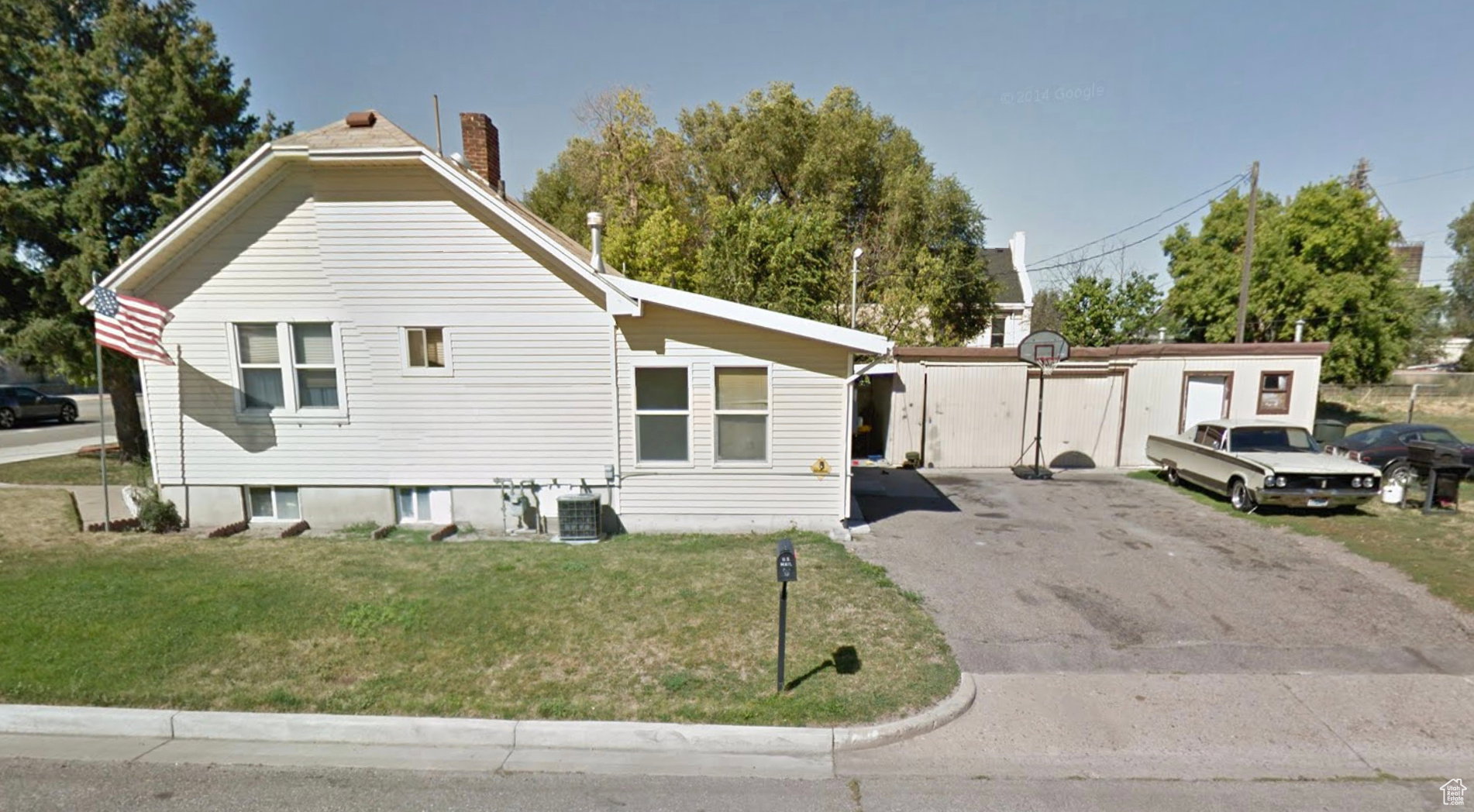 View of home's exterior featuring a yard and a chimney