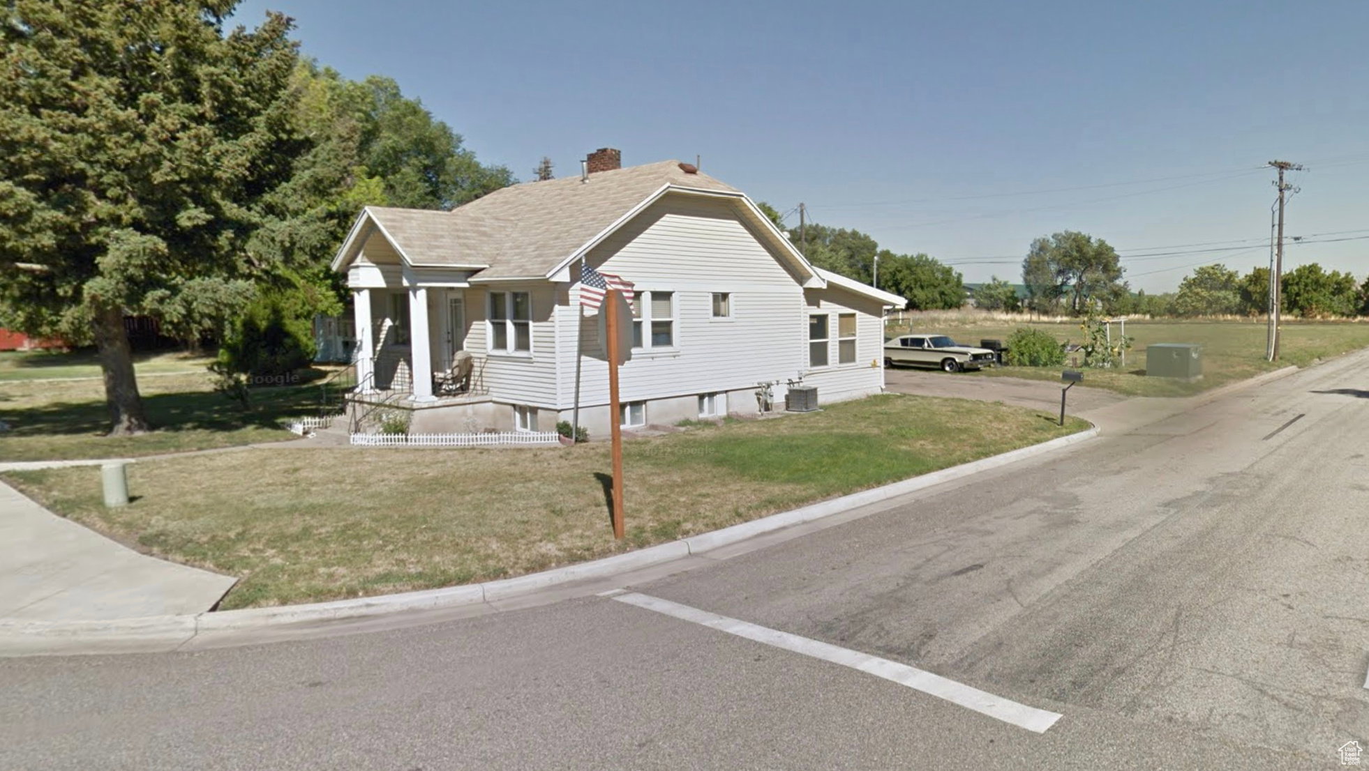 Bungalow-style house with a front yard and a chimney