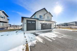View of front of property featuring stone siding and an attached garage