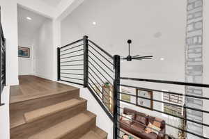 Stairway featuring recessed lighting and wood finished floors