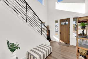 Foyer featuring wood finished floors and a high ceiling