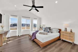 Bedroom with recessed lighting, wood finished floors, multiple windows, a ceiling fan, and an office area