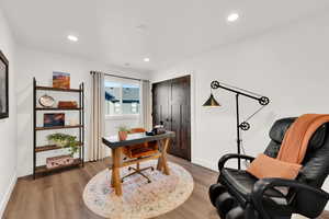 Office area featuring light wood-style flooring and recessed lighting