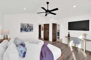 Bedroom with a ceiling fan, lofted ceiling, wood finished floors, and recessed lighting