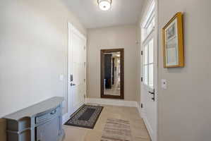 Doorway to outside with plenty of natural light and tile patterned flooring