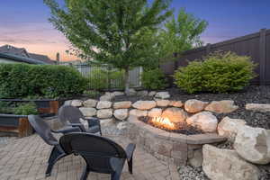Fenced backyard featuring a patio and an outdoor fire pit