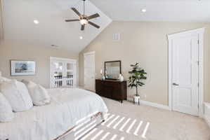 Bedroom featuring recessed lighting, vaulted ceiling, light colored carpet, and ceiling fan