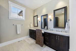 Full bathroom with vanity and decorative backsplash