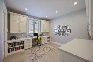 Office area with built in study area and recessed lighting