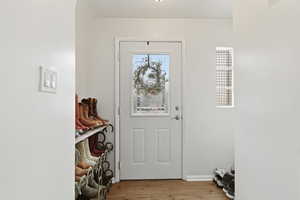Entrance foyer featuring light wood-type flooring and baseboards