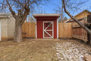 View of shed featuring a fenced backyard