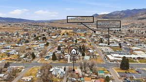 View of property location featuring mountains and nearby suburban area