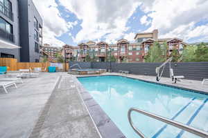 Community pool featuring a patio and a hot tub