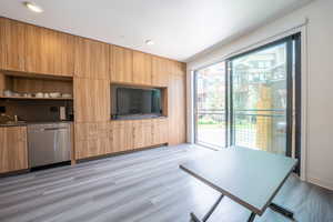 Unfurnished living room featuring light wood-type flooring and a sink