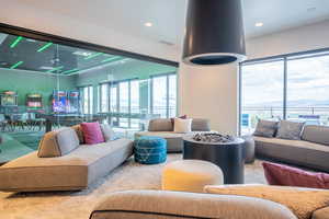 Carpeted living room with recessed lighting