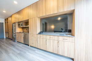Unfurnished living room with recessed lighting and a sink