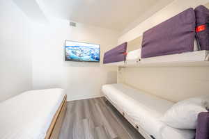 Bedroom featuring light wood-style floors and baseboards