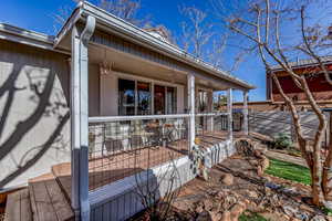 Entrance to property with a porch and board and batten siding