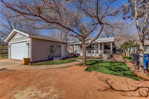 View of front of property with an outbuilding and a detached garage