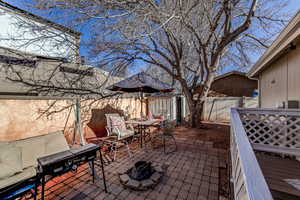 Fenced backyard featuring a patio area, outdoor dining area, and an outdoor fire pit
