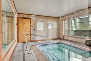 View of swimming pool with an in-ground hot tub