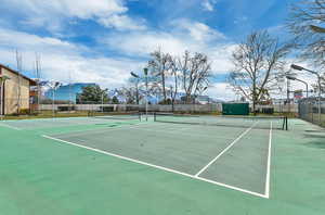 View of tennis court featuring community basketball court