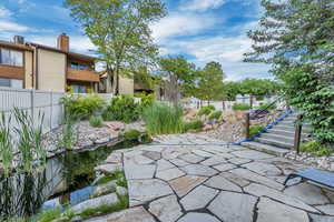 View of patio with a small pond